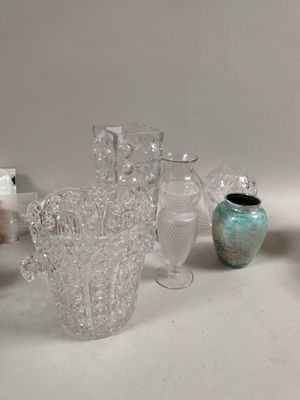 many glass vases sitting on a table next to each other