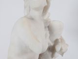 marble statue of a woman holding a flower in her hands