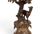 an image of a bronze candle holder with a deer and a bird on it