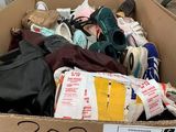 a cardboard box full of shoes and other items in it