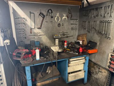 a workbench with tools on it in a garage