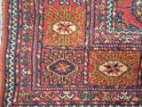 a red and blue rug with a pattern on it