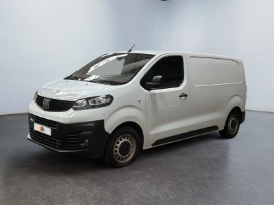the white van is parked in a large room with a black floor