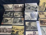 a lot of old postcards that are on a table
