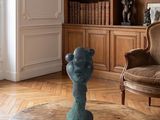 a blue vase sitting on a table in a living room