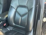 the interior of a car with black leather seats and a center console