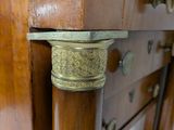 a close up of a wooden cabinet with brass knobs