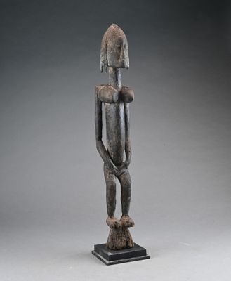 a wooden statue of a man holding a baby in his arms