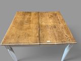 an image of a wooden table with metal legs on a gray background