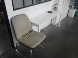 a chair and a table in a room with a picture on the wall