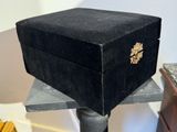 a black box sitting on top of a metal stand