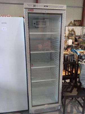 a refrigerator that is sitting in the middle of a room