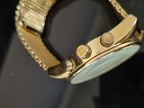 a close up of a watch on display in a glass case