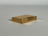 a gold lighter that is sitting on a table
