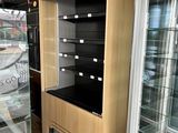 a display case in the middle of a store with glass doors