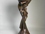 statue of a woman holding a bowl on her head