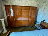 a bedroom with a bed and a cabinet in it