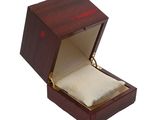 a wooden box with a ring in it on a white background