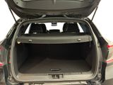the back of a car with its trunk open and the back seats folded down