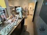 a picture of a kitchen with a lot of food on the counter