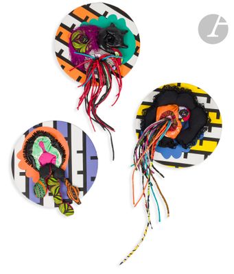 three paper plates with different designs on them on a white surface