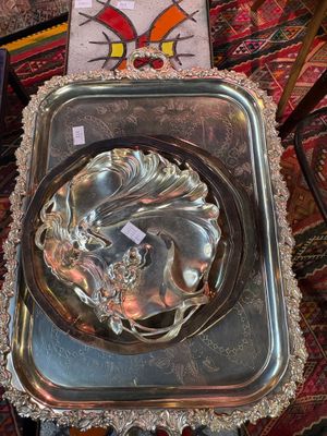 a silver tray with a bowl on it on a rug
