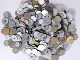 a pile of old coins on a white surface