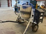 concrete mixer in a warehouse with a hose attached to it