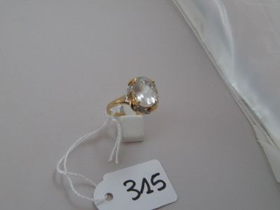 a ring with a white stone on it and a price tag attached to it
