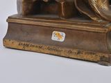 bronze statue of a man with a hat on his head on a base