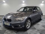 a picture of a grey bmw car in a showroom