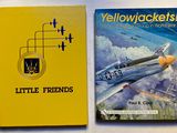 two books on a table with a yellow cover and a yellow book with a picture of a plane on it