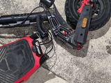 a scooter that is laying on the ground next to a skateboard