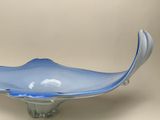 a blue glass bowl sitting on top of a table