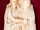a carved ivory plaque of two women and a child