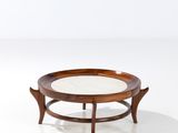 a round coffee table with a glass top on a white surface