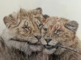painting of a couple of lion cubs resting on a tree branch
