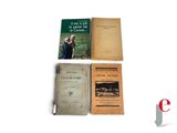 three books are sitting on a white surface next to each other