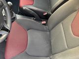 the interior of a car with red and gray seats and a steering wheel