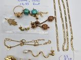a lot of jewelry on a table with a price tag