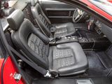 a red car with black leather seats in the back of it