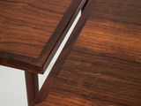 the two tables are made out of wood and have a small table top