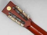 an old guitar with a wooden body and a wooden case