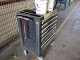 a metal cart with buckets on top of it in a warehouse