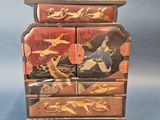 an image of a wooden chest of drawers with birds and flowers painted on it