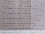 an old document with writing on it sitting on top of a table
