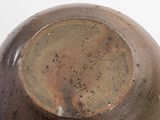 a close up of a vase on a white surface