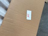 a cardboard box with a sticker on it sitting on the floor