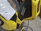 a yellow and black power washer sitting on the floor