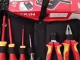 many tools in a tool bag that are on the table